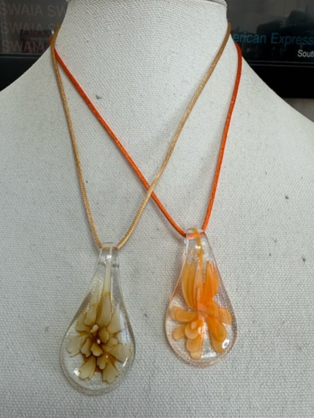 Two tear drop glass flower necklaces on satin cord
